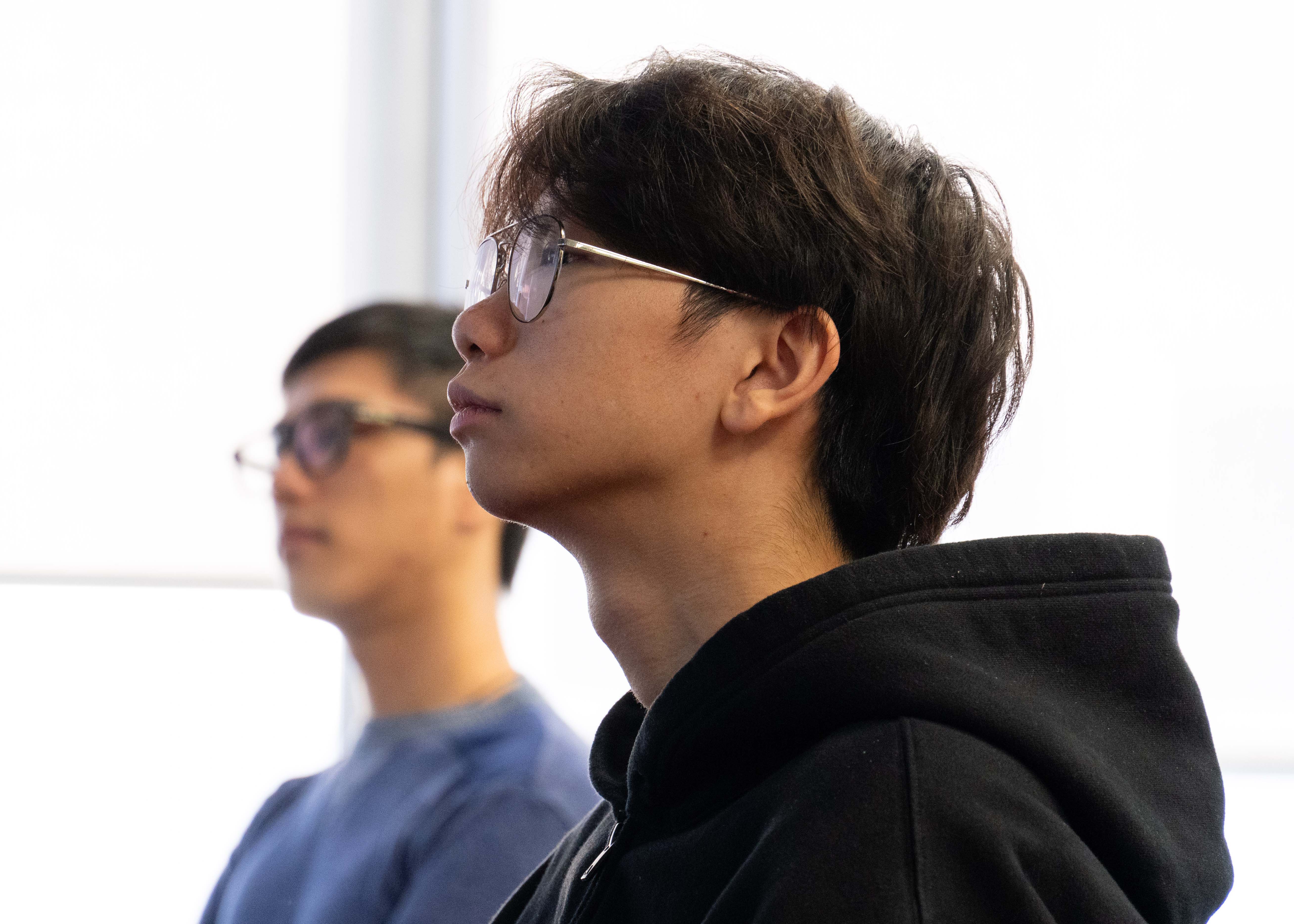 Two psychology students listening to a presentation.